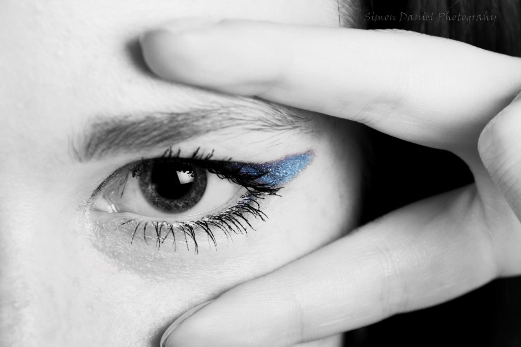 Close-up of eye showing Latisse eyelashes and blue eyeshadow